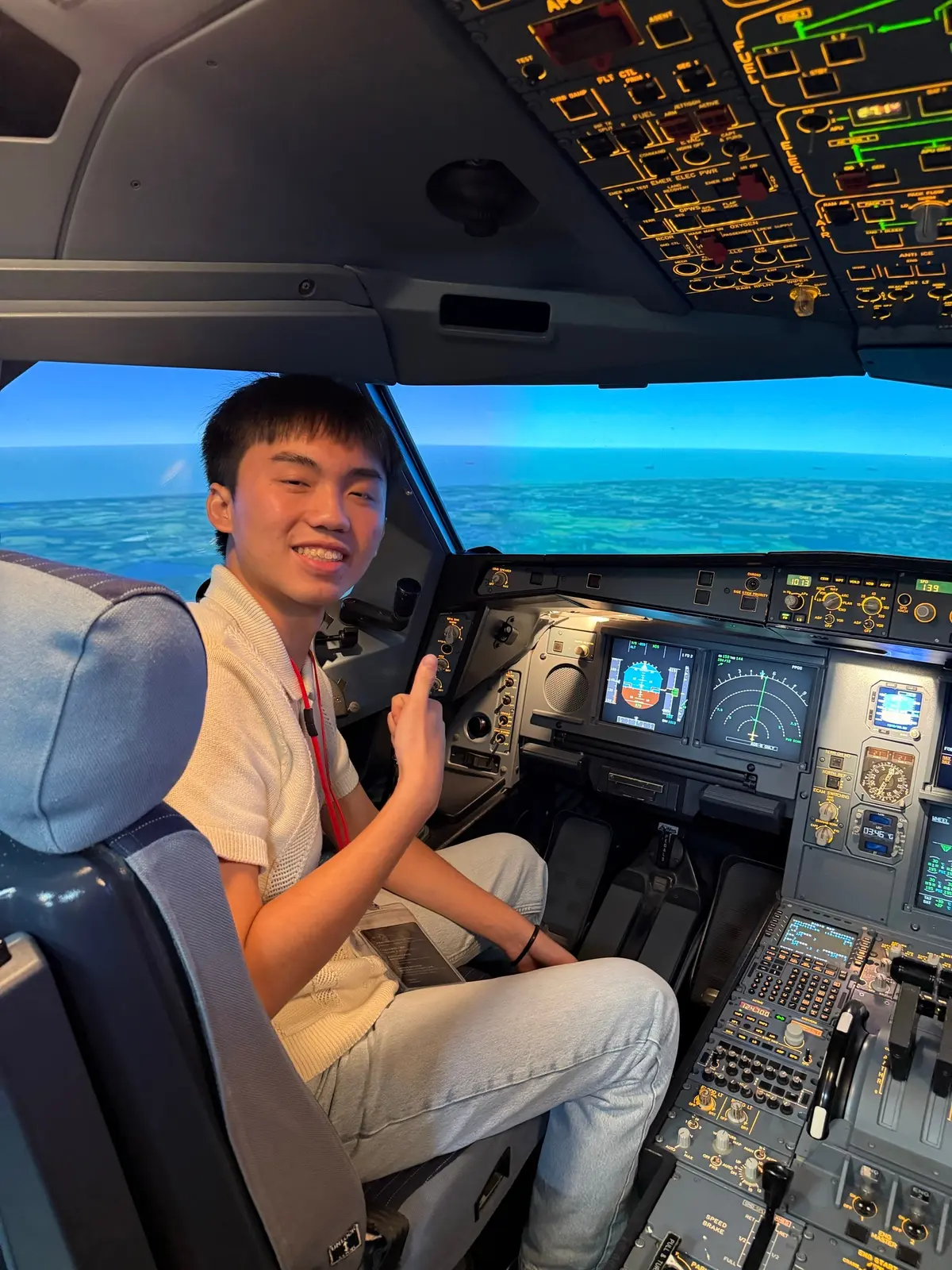 Alen Hsiao in the seat of an airliner flight simulator.