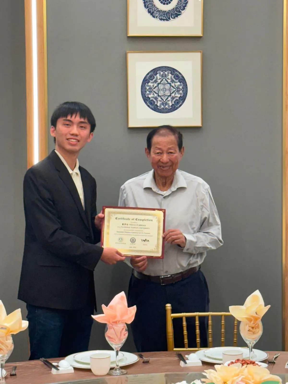 Alen Hsiao holding a certificate with another person.